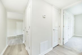 Riverdale townhouse for rent - A hallway with white walls and wood flooring.