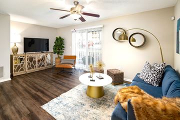 Atlanta apartment for rent - A living room with a blue couch and a gold coffee table.