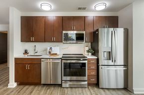 Atlanta apartment for rent - a kitchen with stainless steel appliances and wooden cabinets