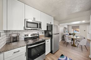 Smyrna apartment for rent - A kitchen with white cabinets and a black refrigerator.