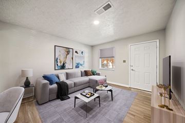 Smyrna apartment for rent - A living room with a grey couch and a grey chair.