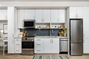 Atlanta apartment for rent - a kitchen with white cabinets and stainless steel appliances