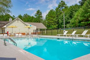 Lithonia apartment for rent - a swimming pool with chairs and a house in the background