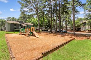 Stone Mountain apartment for rent - A playground with a slide and a wooden fence.