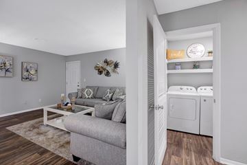 Peachtree Corners apartment for rent - A living room with a grey couch and a coffee table.