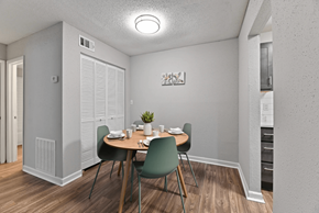 Austell apartment for rent - A dining room with a table set for two and a potted plant.