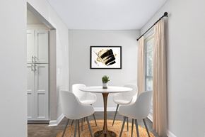 Decatur townhouse for rent - a dining room with a table and chairs and a painting on the wall