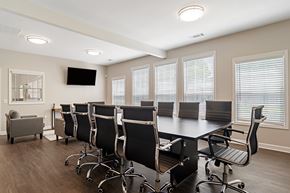 Atlanta apartment for rent - A conference room with a long table and chairs.