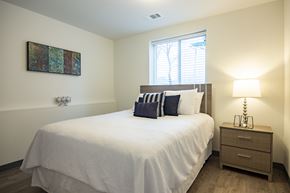 Atlanta apartment for rent - A bedroom with a bed, nightstand, and lamp.