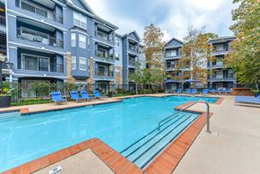 Atlanta apartment for rent - A swimming pool surrounded by apartment buildings.