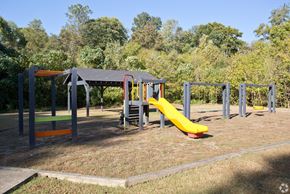 Smyrna apartment for rent - A playground with a yellow slide and a red and yellow climbing frame.