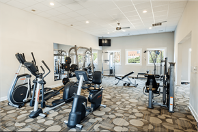 Charlotte apartment for rent - A gym with a variety of exercise equipment including treadmills, stationary bikes, and weight machines.