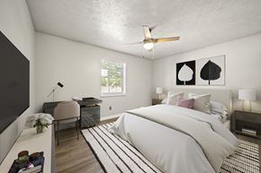 Smyrna apartment for rent - A bedroom with a large bed and a ceiling fan.