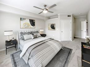 Atlanta apartment for rent - A bedroom with a large bed and a ceiling fan.