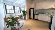 Philadelphia apartment for rent - A kitchen with white cabinets and a black fridge is shown. at 1600 Callowhill, Philadelphia, PA
