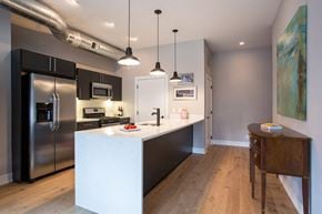 Philadelphia apartment for rent - a kitchen with a large island and a stainless steel refrigerator