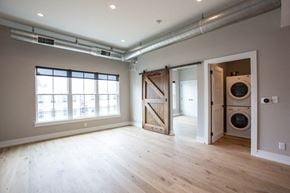 Philadelphia apartment for rent - a living room with a washer and dryer and a door to a bathroom