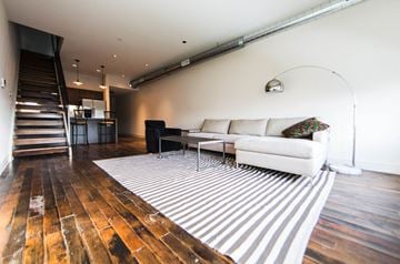 Philadelphia apartment for rent - a living room with a white couch and a striped rug