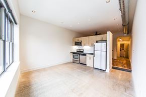 Philadelphia apartment for rent - a kitchen with white cabinets and a white refrigerator