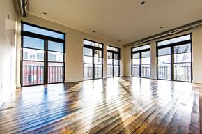 Philadelphia apartment for rent - an empty living room with wood floors and large windows