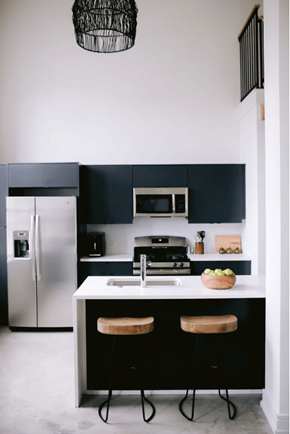 Philadelphia apartment for rent - a kitchen with black cabinets and a white counter top and a refrigerator