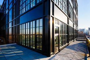 Philadelphia apartment for rent - the corner of an office building with glass windows and a balcony