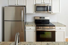 Philadelphia apartment for rent - a kitchen with stainless steel appliances and white cabinets