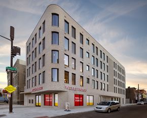 Philadelphia apartment for rent - a large white building with a car parked in front of it