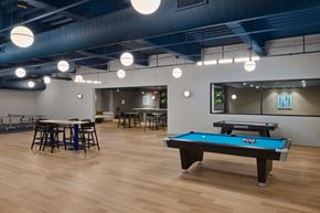 Philadelphia apartment for rent - A pool table is in the middle of a room with a bar and a ping pong table.