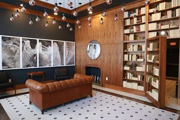 Philadelphia apartment for rent - A living room with a brown leather couch and a fireplace.