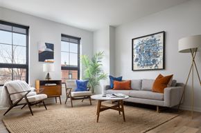 Philadelphia apartment for rent - a living room with a couch and chairs and a table