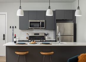 Philadelphia apartment for rent - a kitchen with black cabinets and a white counter top