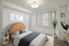 Philadelphia apartment for rent - A bedroom with a large bed and a wooden headboard.