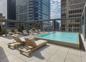 Philadelphia apartment for rent - A pool with sun loungers on a balcony overlooking a city. at 17 Market West, Pennsylvania