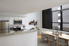 Philadelphia apartment for rent - a kitchen and dining area with a table and chairs and a refrigerator