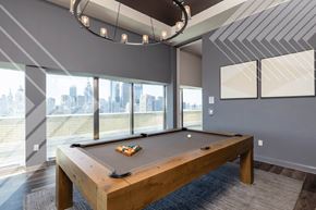 Philadelphia apartment for rent - A pool table in a room with a view of the city.