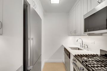 New York apartment for rent - A modern kitchen with a stainless steel refrigerator and oven.