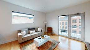 Fort Wayne apartment for rent - A living room with a couch, a chair, a coffee table, and a rug.