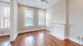 Cincinnati apartment for rent - A room with wooden floors and a fireplace.