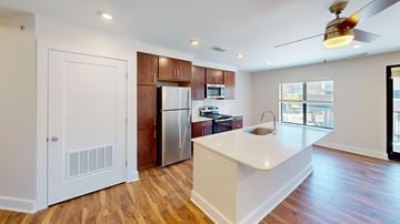Cincinnati apartment for rent - A kitchen with a white island and wooden floors.
