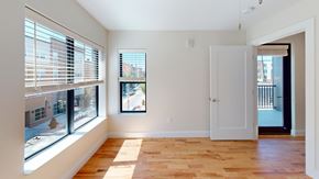 Cincinnati apartment for rent - A room with a wooden floor and a window with blinds.
