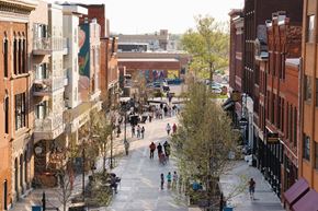 Fort Wayne apartment for rent - A city street with people walking and trees.