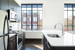 Cincinnati apartment for rent - an empty kitchen with a sink and a window
