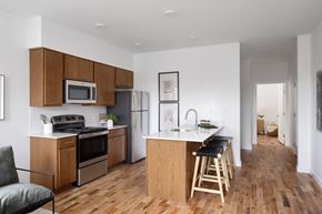 Cincinnati apartment for rent - A kitchen with wooden floors and furniture.