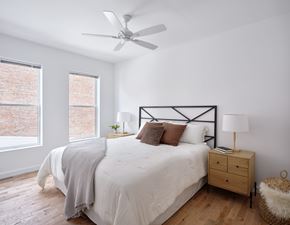 Cincinnati apartment for rent - A bedroom with a bed, nightstand, and window.