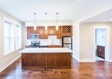 Cincinnati apartment for rent - a kitchen with wooden cabinets and a white counter top