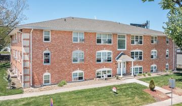 Des Moines apartment for rent - A red brick building with a white door and windows.