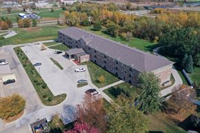Pleasant Hill apartment for rent - A large building with a parking lot in front of it.