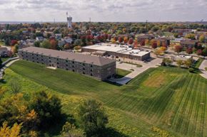 Pleasant Hill apartment for rent - an aerial view of the barracks complex with a green field in the foreground