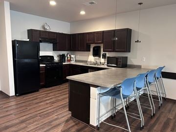 Pleasant Hill apartment for rent - A kitchen with dark wood floors and white walls.